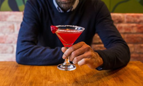 man holding cocktail