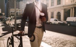 man walking with bike and coffee